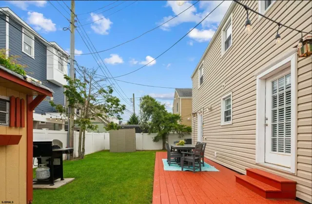 a view of a backyard with plants and a patio
