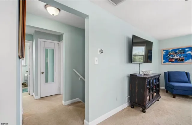 a view of a livingroom with workspace and a couch