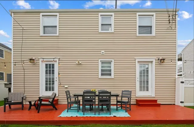 a backyard view of a house with seating space
