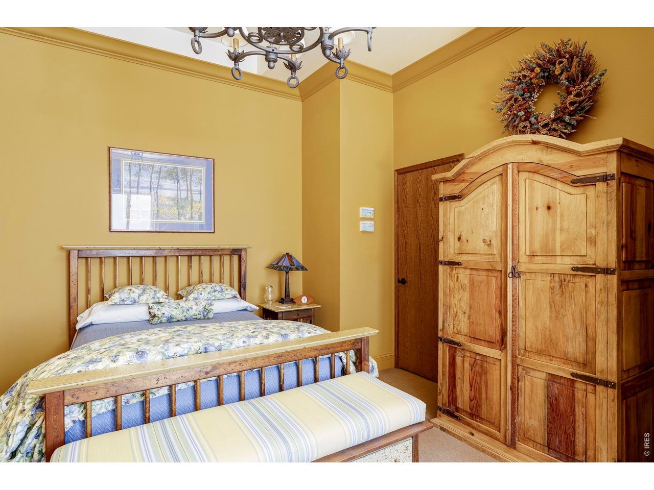 86 South Cedar Brook Road Boulder, CO 80304 - Photo 33 of 40 a bedroom with a bed and wooden floor