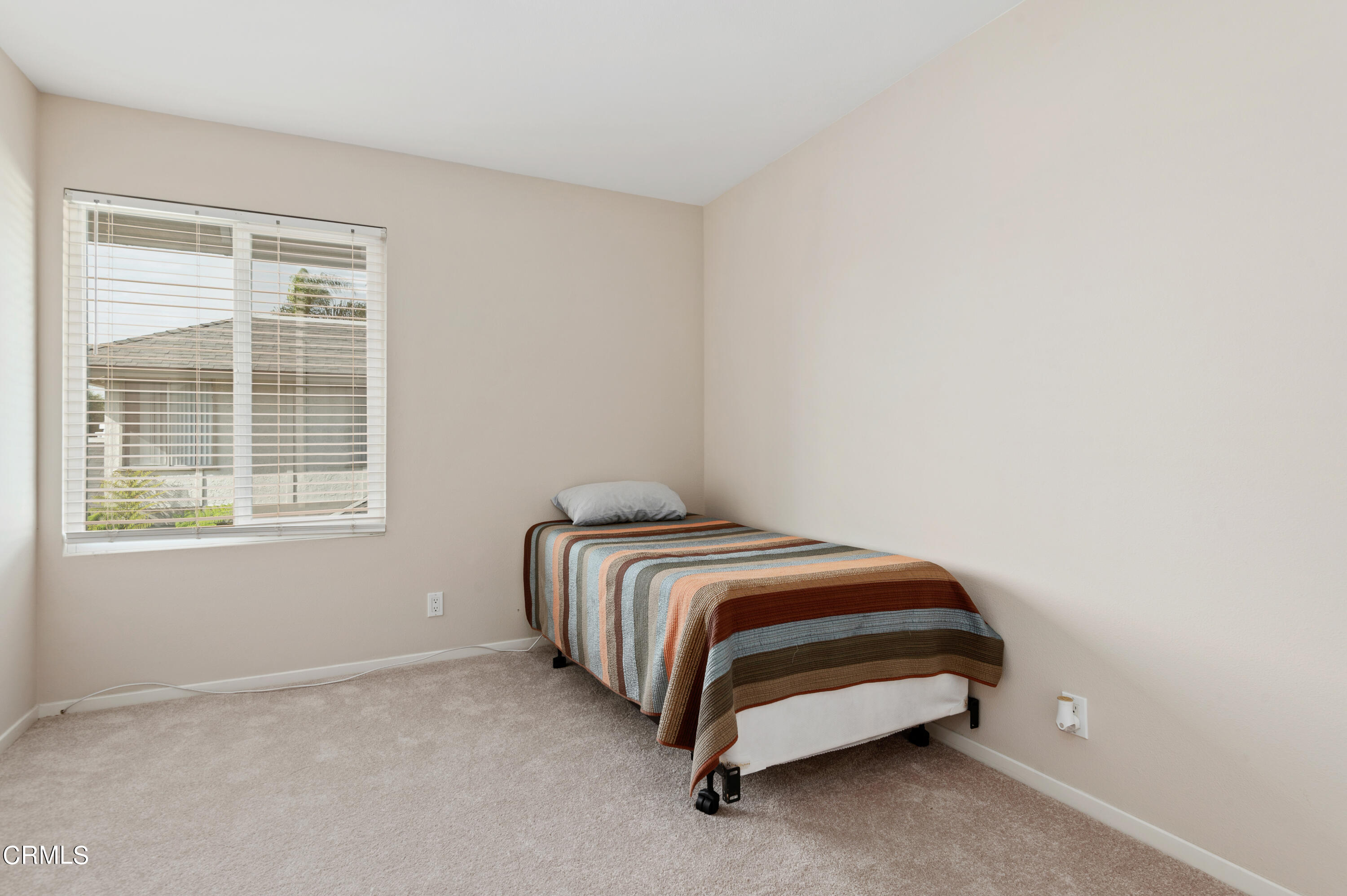 3701 Ketch Avenue, Unit D Oxnard, CA 93035 - Photo 24 of 28 a bed room with a bed and a window