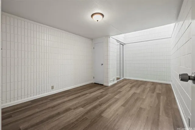 a view of a room with wooden floor