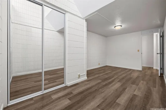 a view of wooden floor and windows in a room