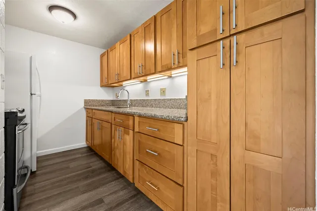 a kitchen with stainless steel appliances granite countertop cabinets and wooden floor