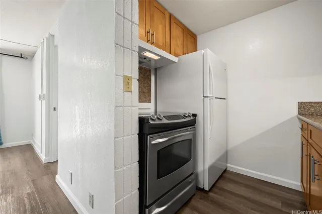 a kitchen with a stove and a refrigerator