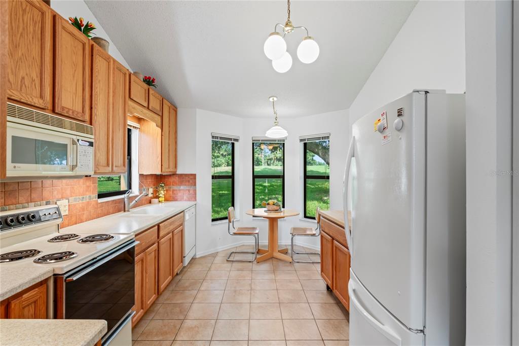 9108 Bassett Lane, Unit B New Port Richey, FL 34655 - Photo 8 of 66 a open kitchen with stainless steel appliances granite countertop a stove and a refrigerator