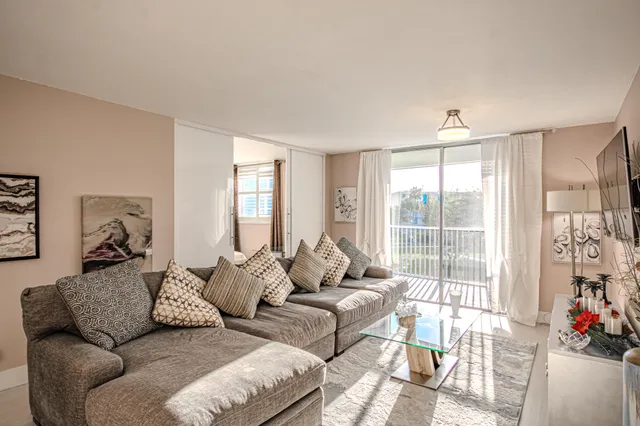 a living room with furniture and a large window