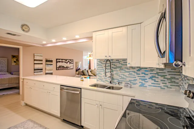 a kitchen with stainless steel appliances granite countertop a sink and cabinets