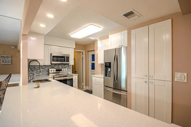 a view of a kitchen from the hallway