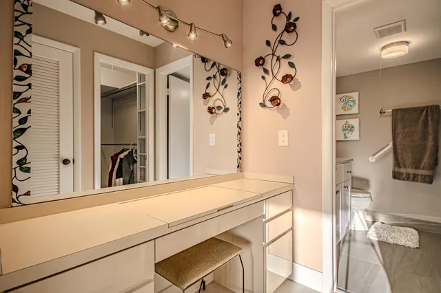 a bedroom with a large bed and a tv