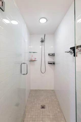 a view of a balcony with floor to ceiling windows with wooden floor