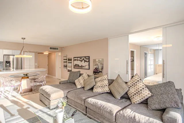 a living room with furniture a window and a chandelier