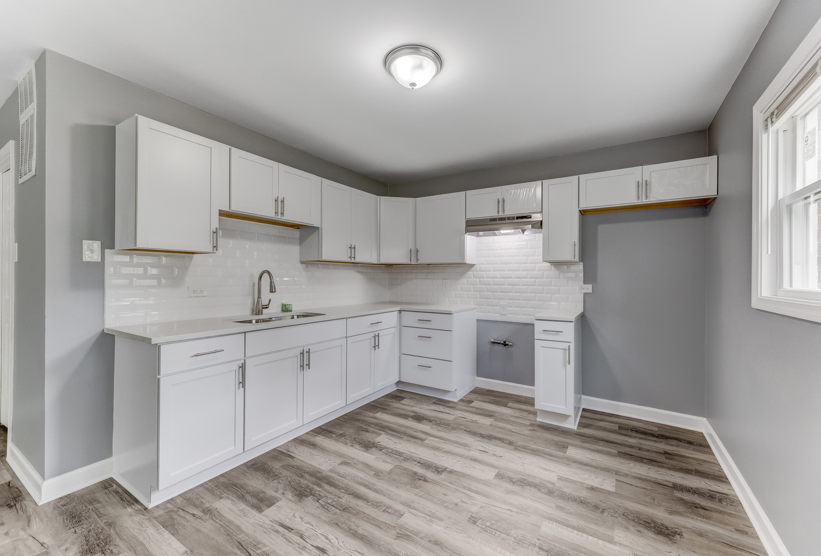 816 Sunnyside Avenue Thornton, IL 60476 - Photo 2 of 2 a kitchen with granite countertop white cabinets and white appliances