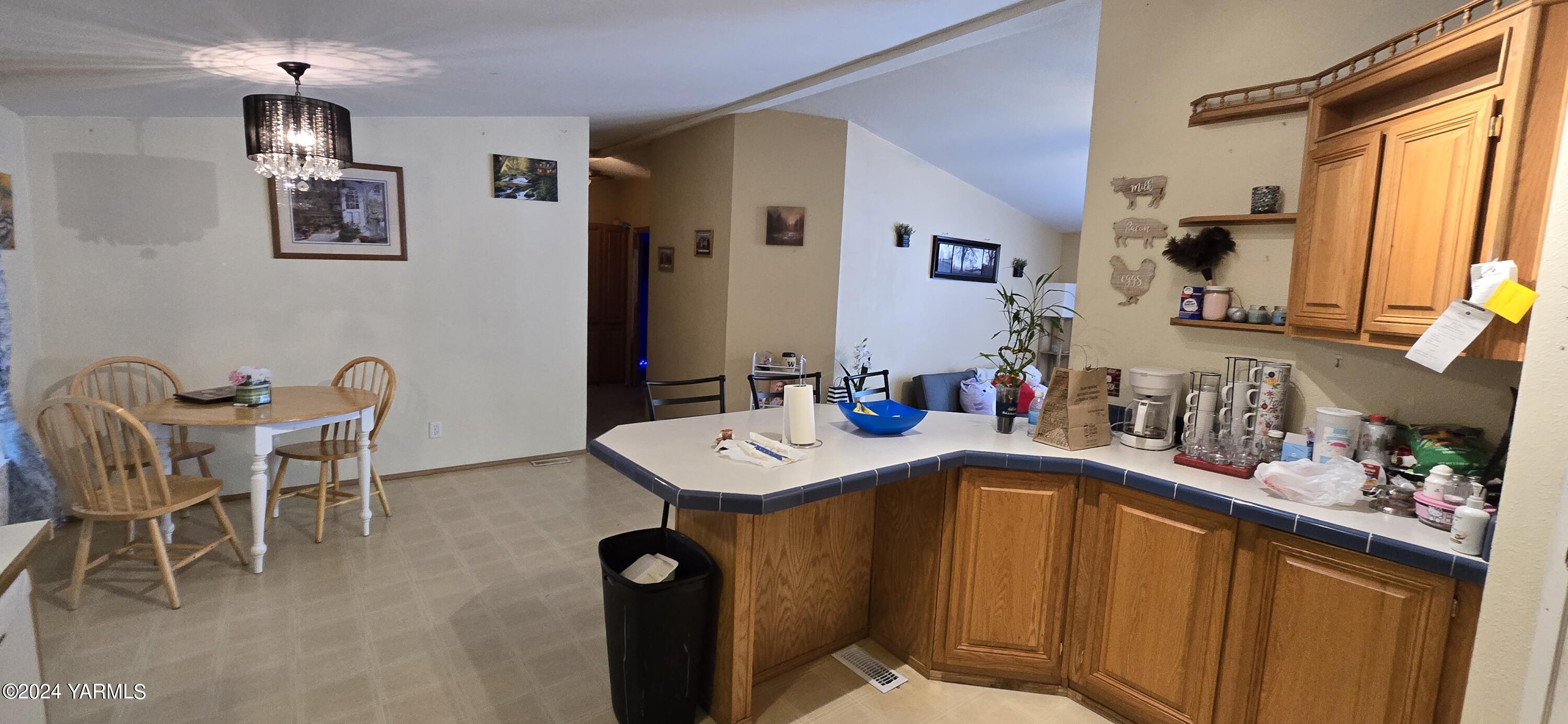 2802 Beaudry Road, Unit 44 Yakima, WA 98901 - Photo 3 of 18 a bath room with a table chairs and a refrigerator