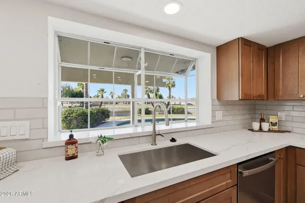 a kitchen with a sink a stove top oven and cabinets