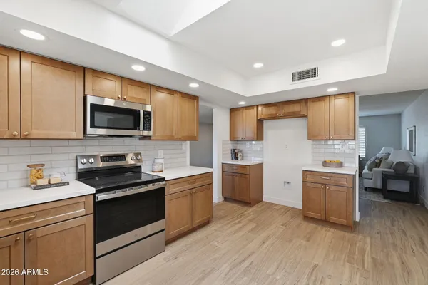 a view of a kitchen with a sink and a microwave
