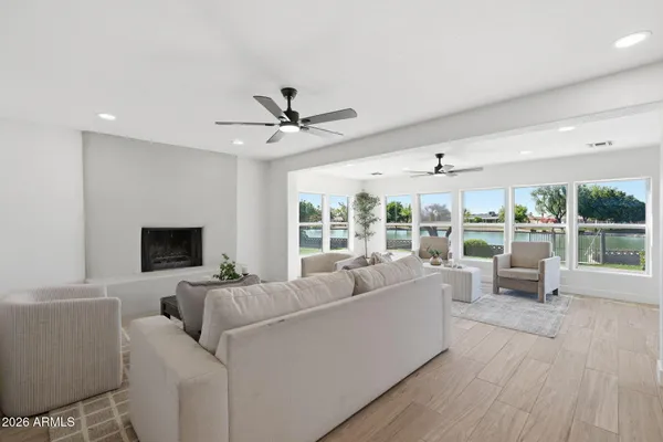 a living room with furniture and a wooden floor