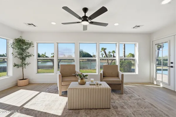 a living room with furniture and a wooden floor