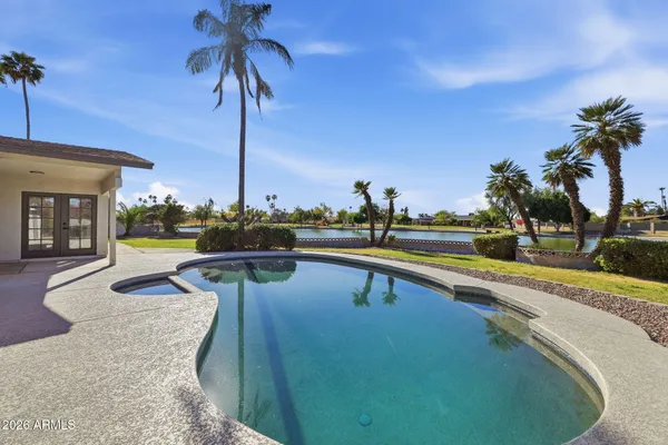 a view of a swimming pool with a table and chairs