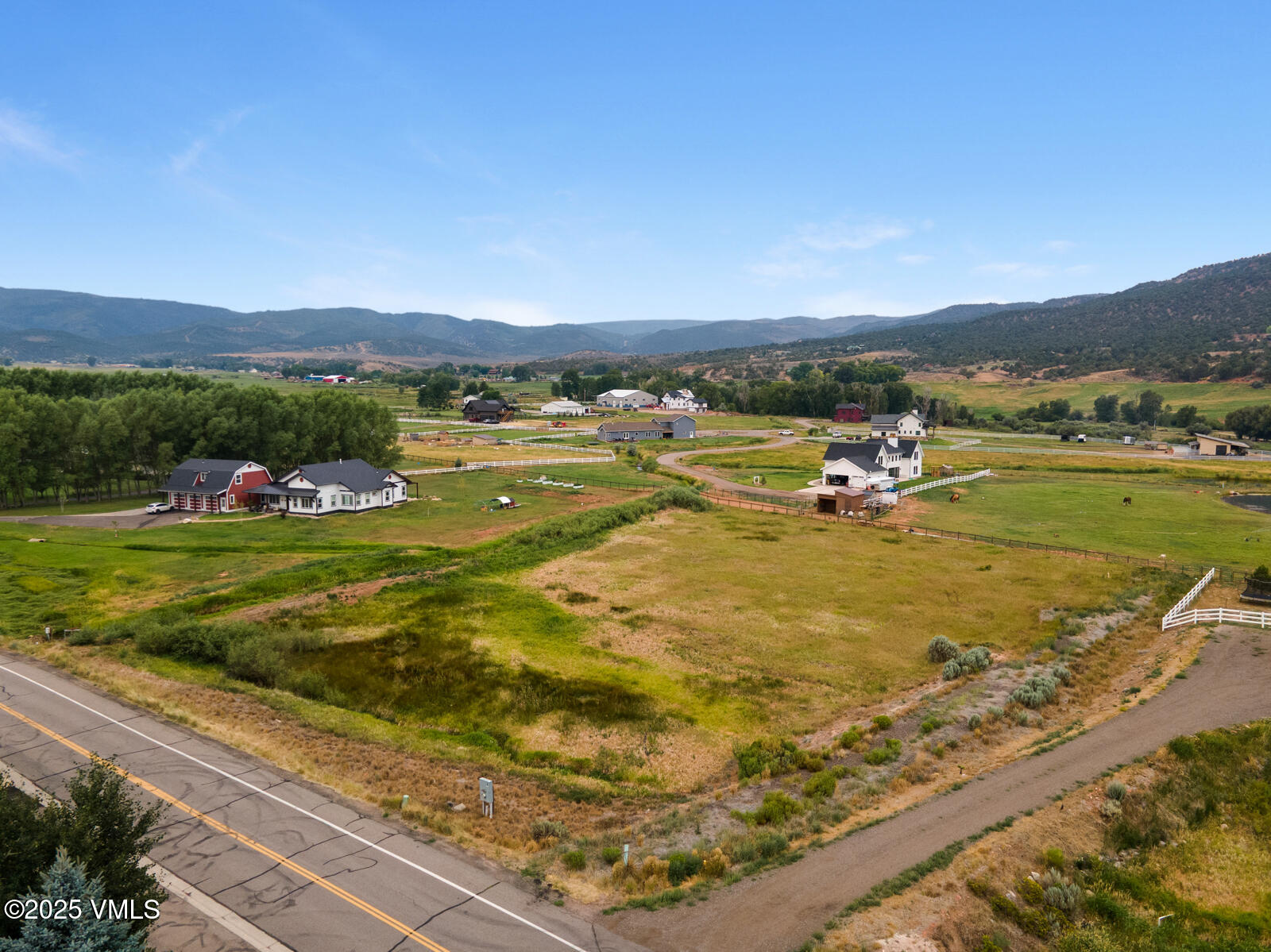 a view of a field with an ocean view