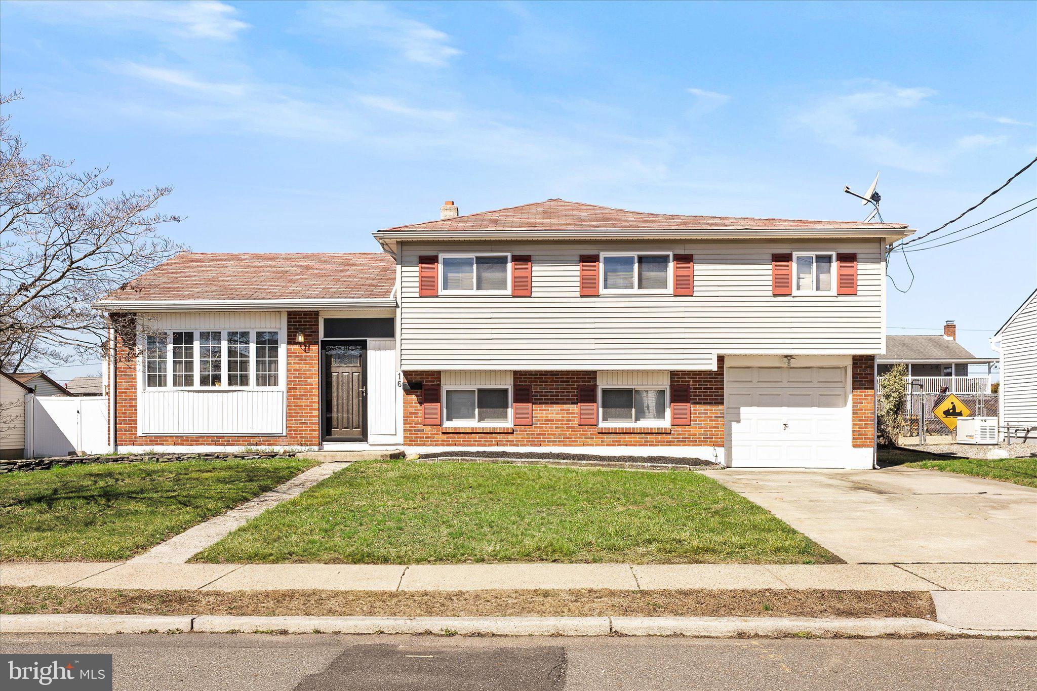 16 Fenway Road Hamilton, NJ 08620 - Photo 1 of 32 a front view of a house with a yard and garage