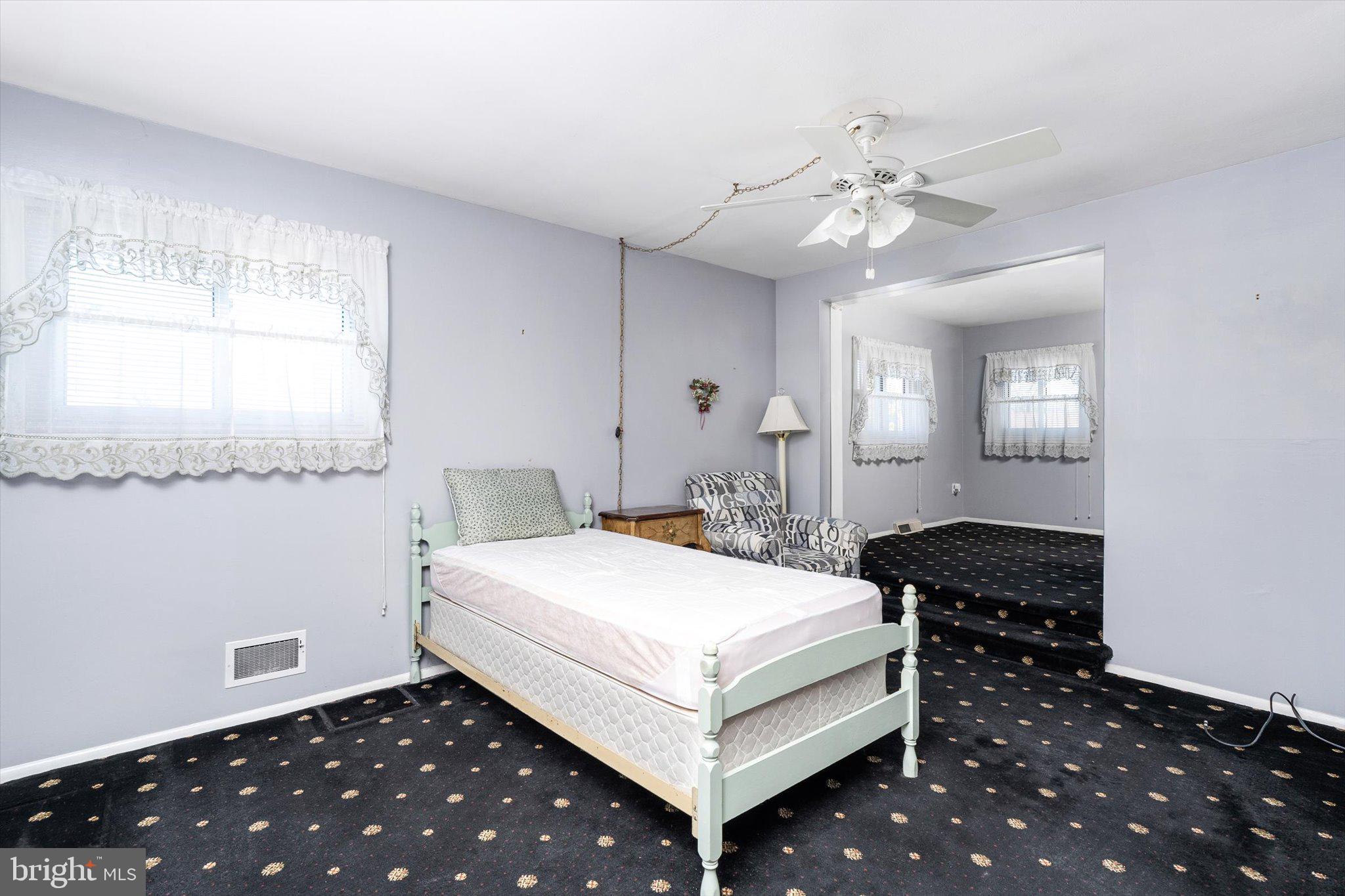 16 Fenway Road Hamilton, NJ 08620 - Photo 16 of 32 a bedroom with a bed and a chandelier