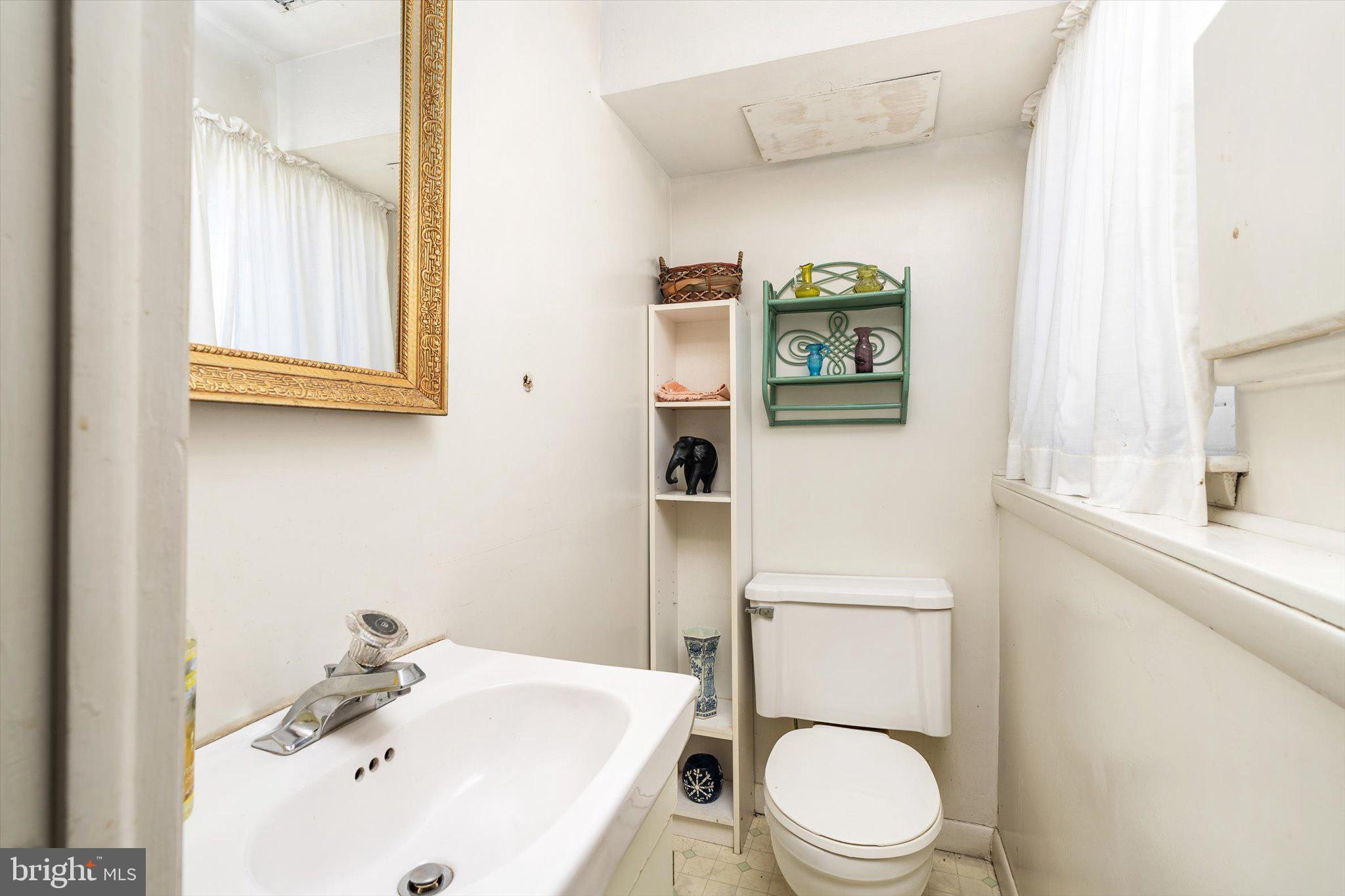 16 Fenway Road Hamilton, NJ 08620 - Photo 25 of 32 a white toilet sitting next to a bathroom sink