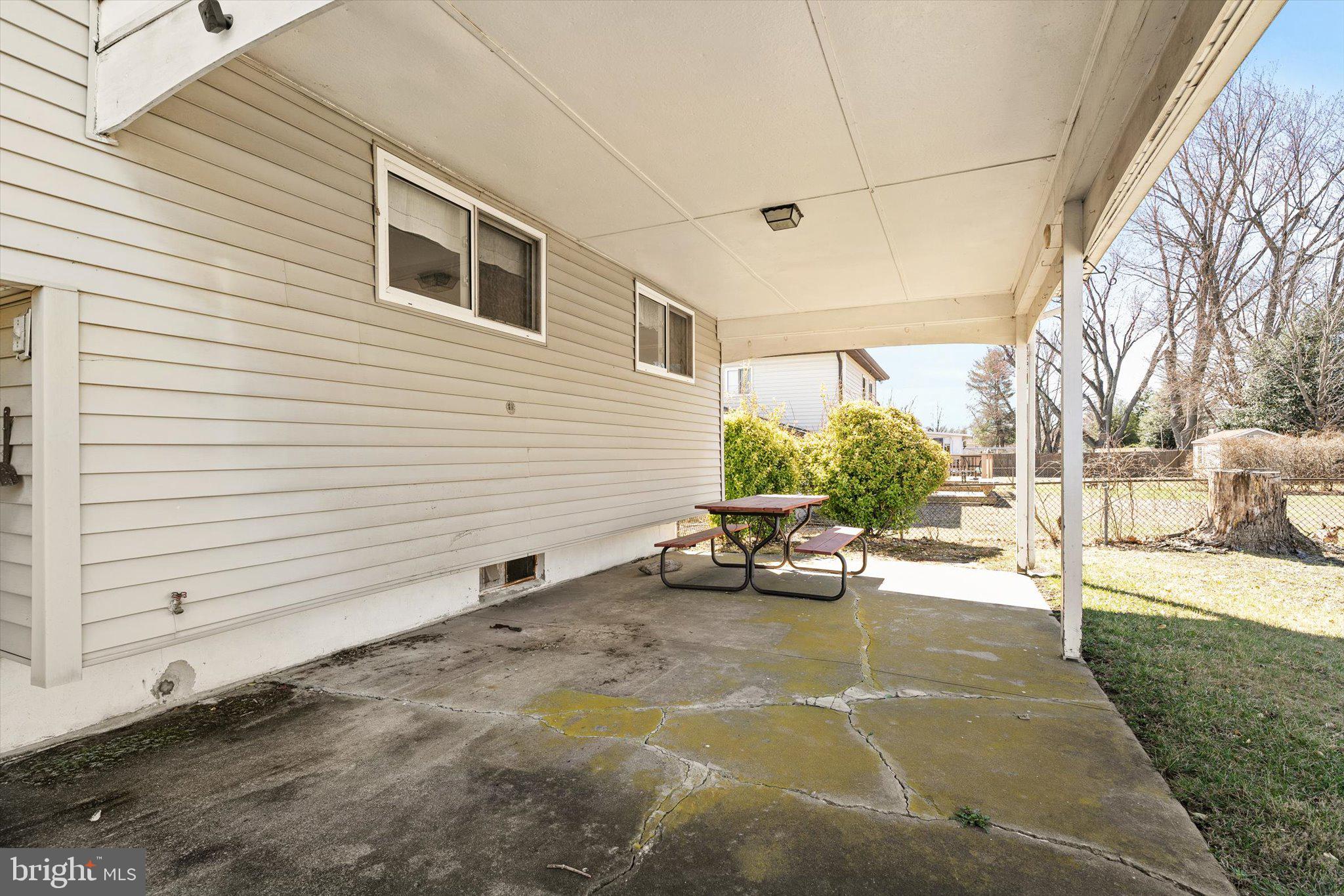 16 Fenway Road Hamilton, NJ 08620 - Photo 28 of 32 a view of a patio with dining table and chairs with wooden fence