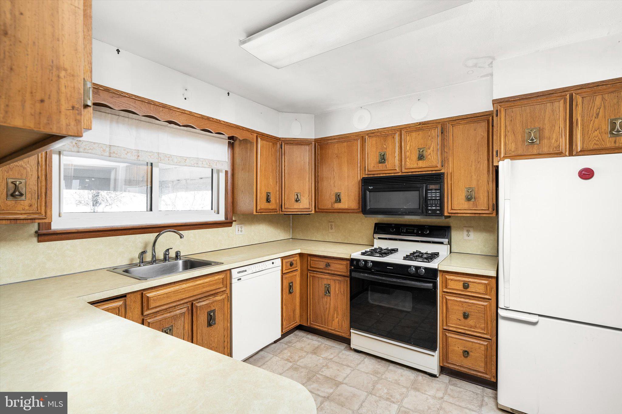 16 Fenway Road Hamilton, NJ 08620 - Photo 10 of 32 a kitchen with stainless steel appliances granite countertop a sink stove and refrigerator