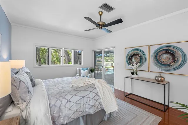 a bedroom with a bed a dresser and a window