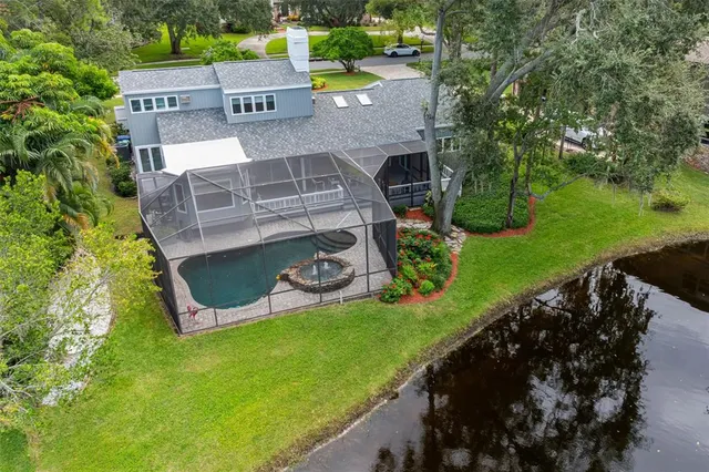 an aerial view of a house with a garden and swimming pool