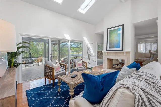 a living room with furniture fireplace and a large window