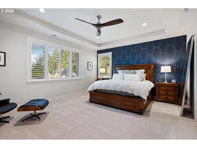 a bedroom with a large bed and a ceiling fan