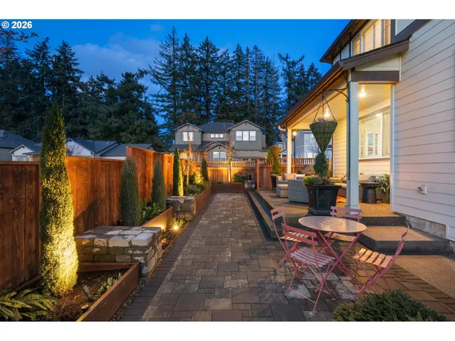 a backyard of a house with barbeque oven