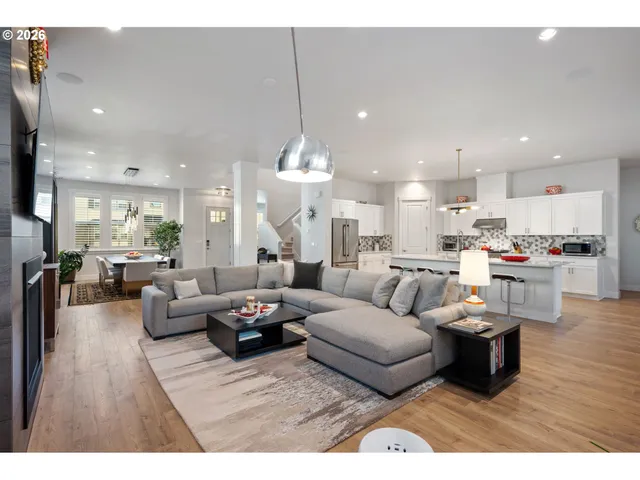 a kitchen with kitchen island a sink stainless steel appliances and cabinets