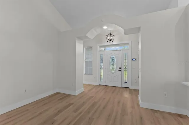 a view of an entryway with wooden floor and a livingroom