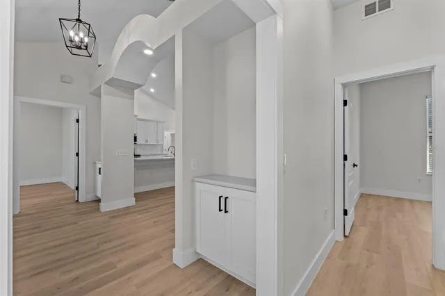 a large kitchen with stainless steel appliances a large counter top a sink a stove and a refrigerator