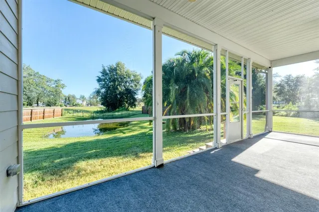 a view of backyard with deck and a garden