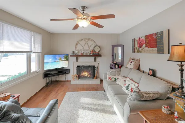 a living room with furniture a flat screen tv and a fireplace