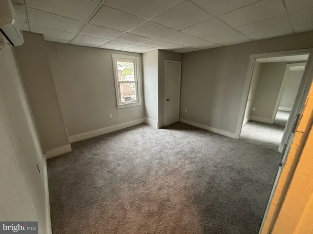 a view of an empty room and a window