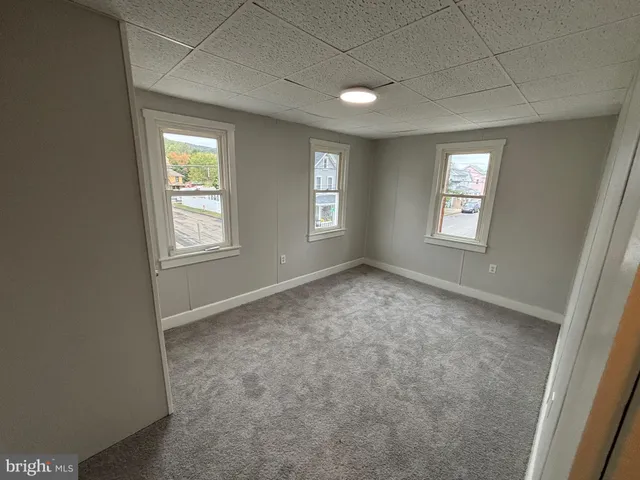 a view of an empty room with windows