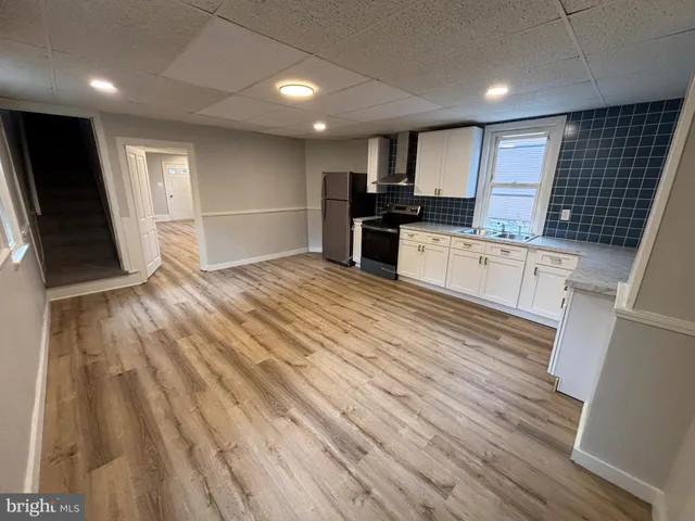 a view of kitchen with microwave and refrigerator