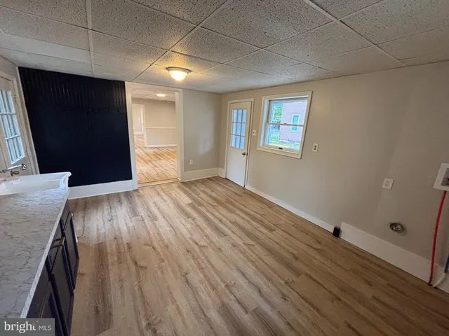 a view of an empty room with wooden floor