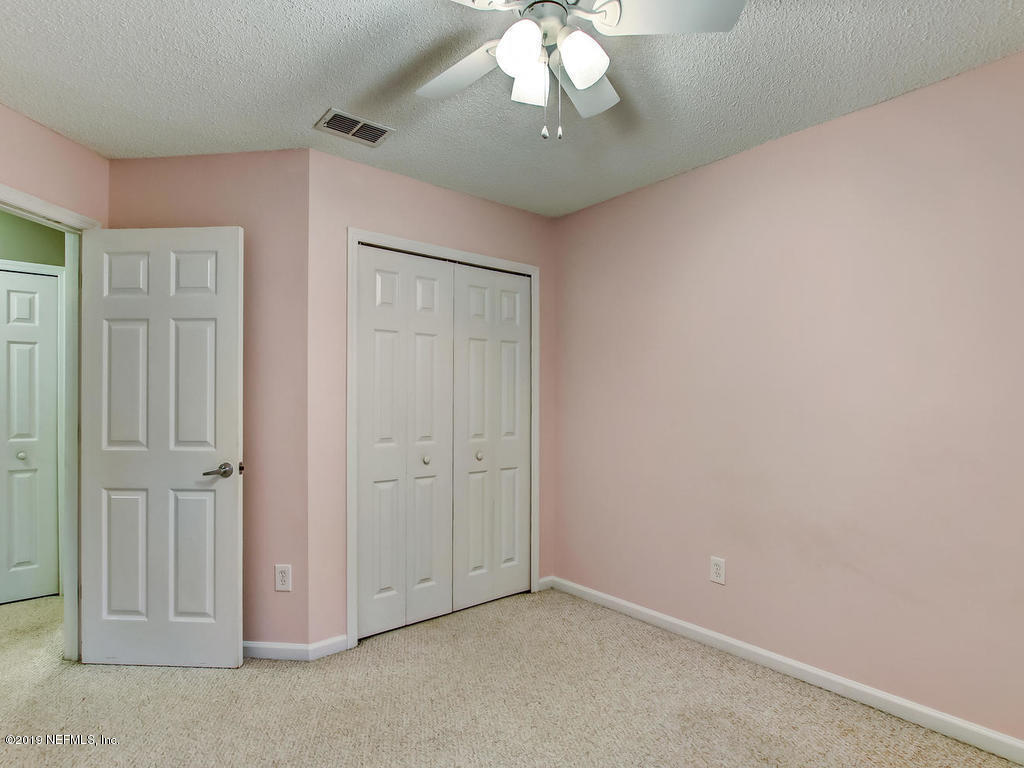 573 Prosperity Lake Drive St. Augustine, FL 32092 - Photo 16 of 23 an empty room with a chandelier fan