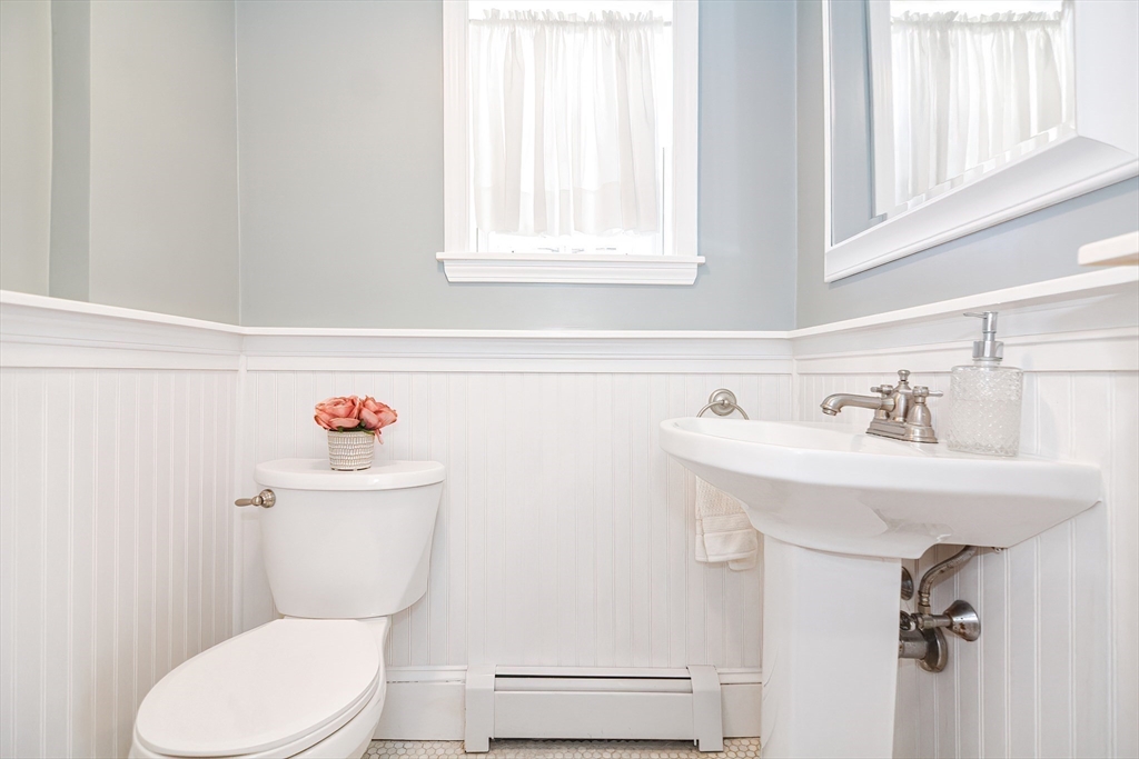 58 Holmes Road Dedham, MA 02026 - Photo 12 of 29 a bathroom with a sink a toilet and a window
