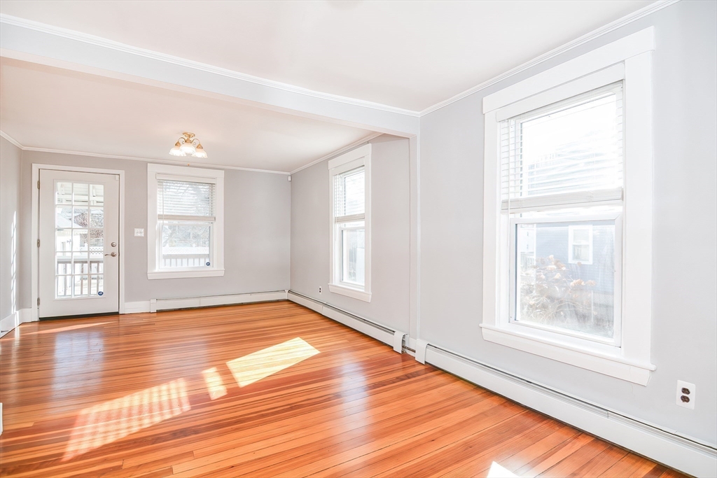 58 Holmes Road Dedham, MA 02026 - Photo 15 of 29 a view of an empty room with window and wooden floor