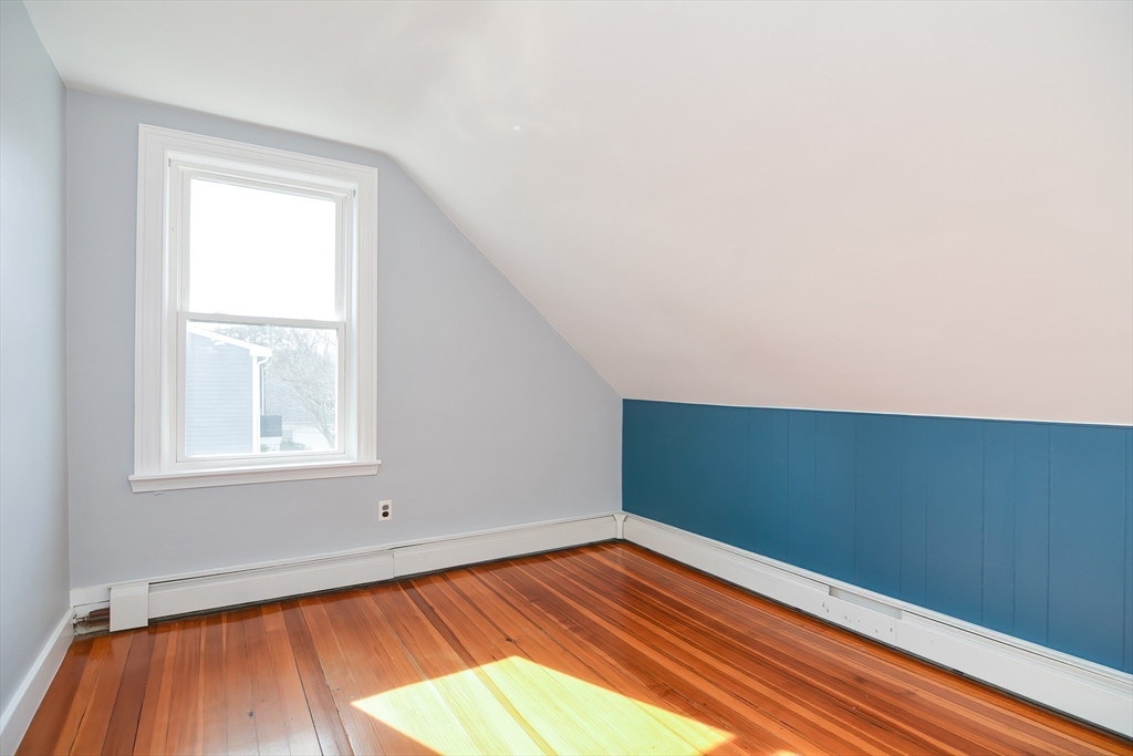 58 Holmes Road Dedham, MA 02026 - Photo 20 of 29 an empty room with wooden floor and windows
