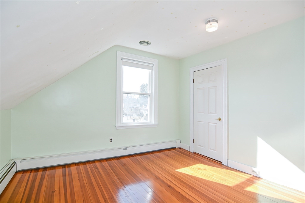 58 Holmes Road Dedham, MA 02026 - Photo 23 of 29 an empty room with wooden floor and windows