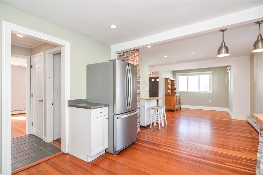 58 Holmes Road Dedham, MA 02026 - Photo 9 of 29 a kitchen with stainless steel appliances a refrigerator and wooden floor