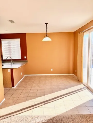 a kitchen with a sink a refrigerator and a stove top oven